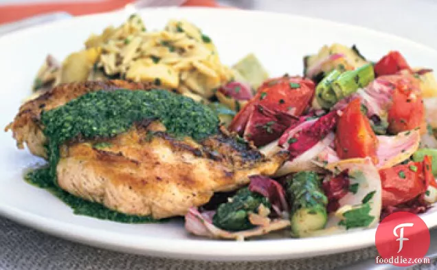 ताजा जड़ी बूटी और लहसुन की चटनी के साथ एक ईंट के नीचे चिकन