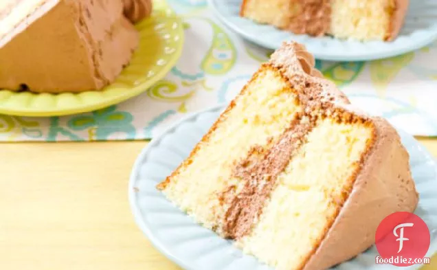 शराबी चॉकलेट गनाचे फ्रॉस्टिंग के साथ पीला जन्मदिन का केक