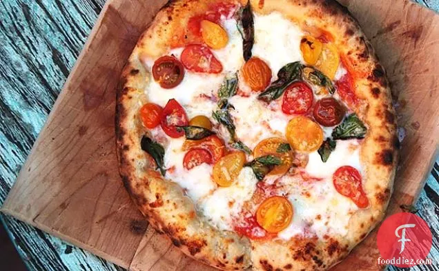 Pizza With Cherry Tomatoes, Garlic, Basil, and Mozzarella