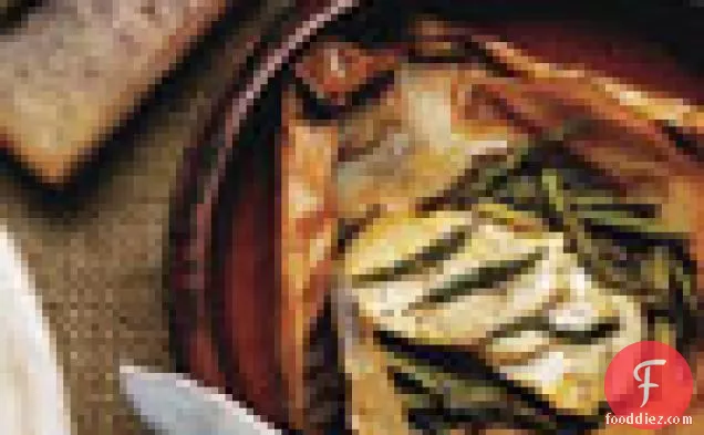 शतावरी और नारंगी के साथ चर्मपत्र में मछली पट्टिका