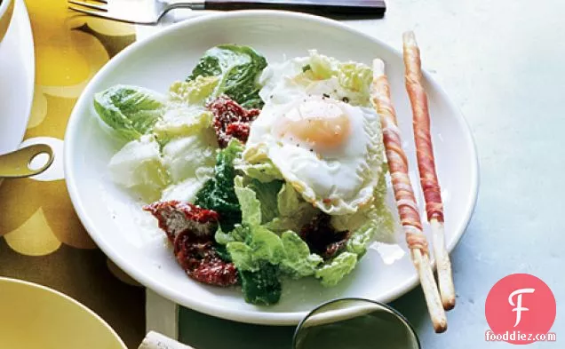 Fried-Egg Caesar with Sun-Dried Tomatoes and Prosciutto Breadsticks