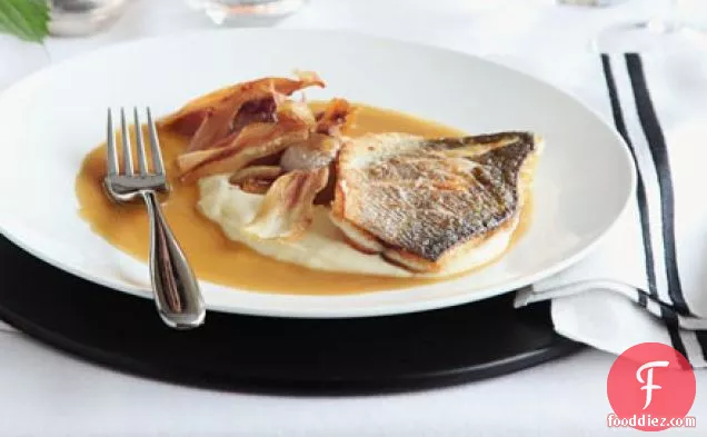 Roast fillet of sea bass with parsnip purée & caramelised garlic