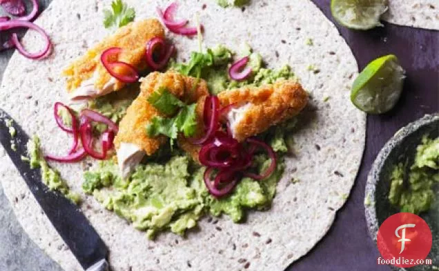Smashed avocado with crispy chicken, pickled onions & tortillas