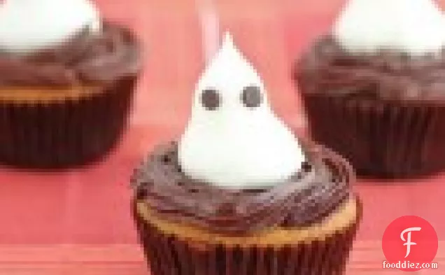 Pumpkin cupcakes with chocolate ganache filling and topped with meringue ghosts