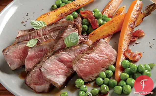Herb-Rubbed New York Strip with Sautéed Peas and Carrots