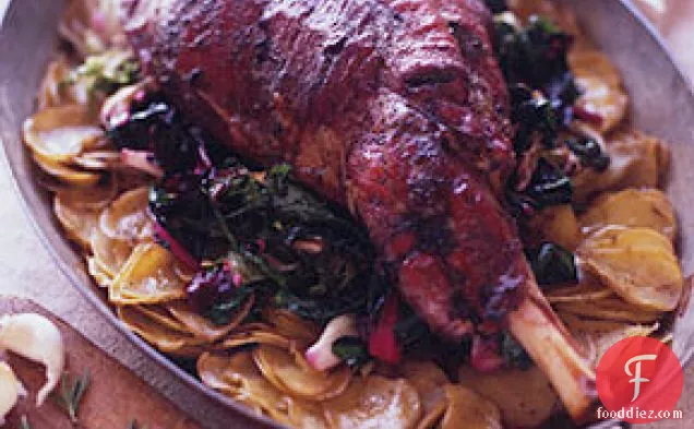 Roast Leg of Lamb on a Bed of Potatoes and Wilted Greens