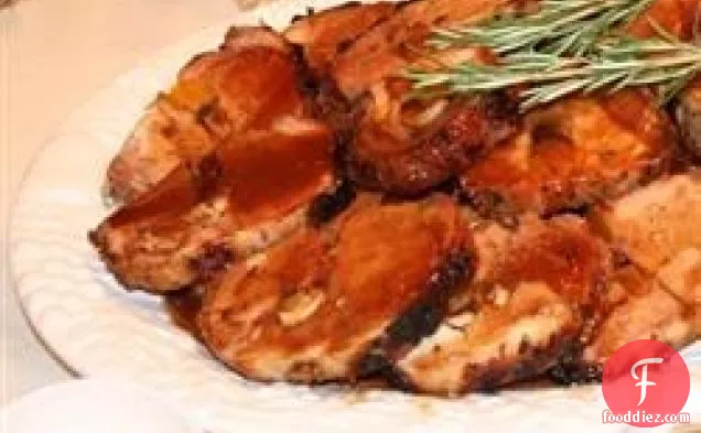 Rosemary-Scented Pork Loin Stuffed With Roasted Garlic, Dried Apricots and Cranberries and Port Wine Pan Sauce