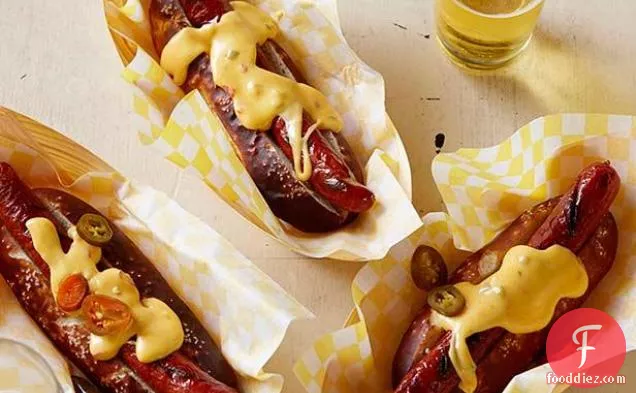 Pretzel Buns with Grilled Dogs and Spicy Cheese Sauce