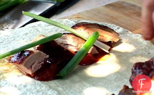 Rotisserie Duck with Hoisin Baste served with Grilled Oranges, Scallions and Pancakes
