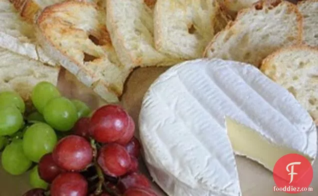Brie Served With Crostini And Grapes