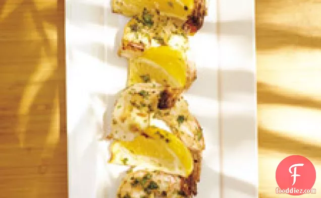 Shrimp Kebabs With Lemon Wedges And Cilantro
