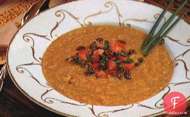सरसों के तेल और टमाटर-चिव टॉपिंग के साथ दाल का सूप